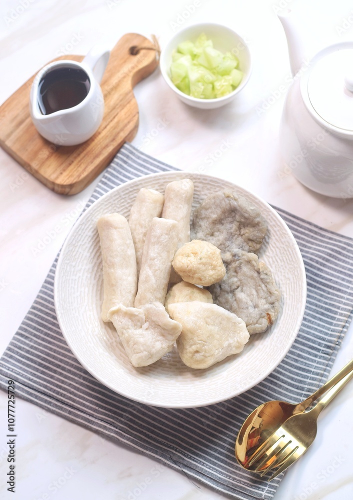 Pempek or empek-empek is a savoury Indonesian fishcake delicacy, made of fish and tapioca, from Palembang, South Sumatera, Indonesia. Pempek is served with rich sweet and sour sauce called cuko Pempek or empek-empek is a savoury Indonesian fishcake delicacy, made of fish and tapioca, from Palembang, South Sumatera, Indonesia. Pempek is served with rich sweet and sour sauce called cuko