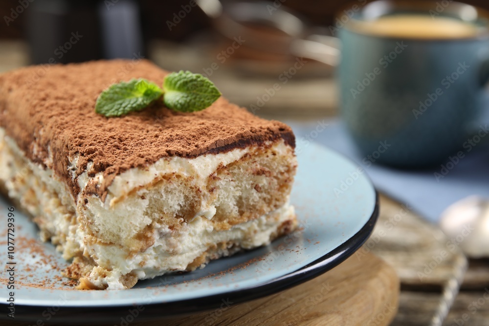 Piece of tasty tiramisu on wooden table, closeup Piece of tasty tiramisu on wooden table, closeup