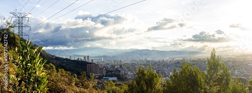 High angle view of Bogota city landscape with electricity tower at sunset, view from mountains
