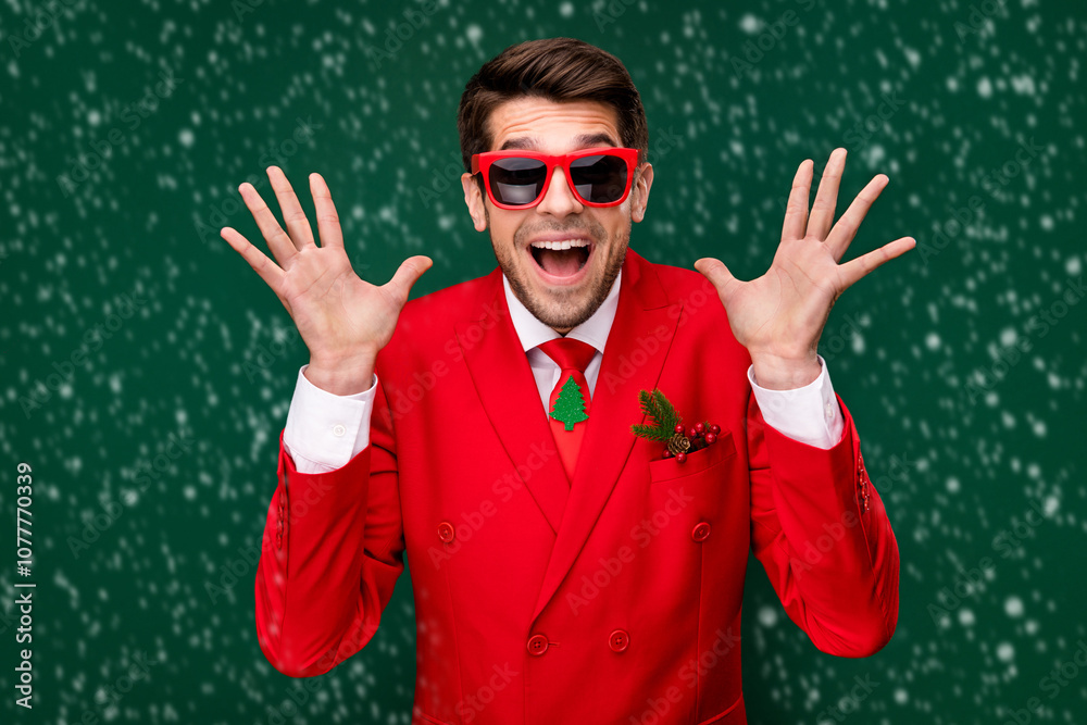 Naklejka premium Photo of cool impressed santa claus guy dressed red jacket glasses rising arms isolated green color background