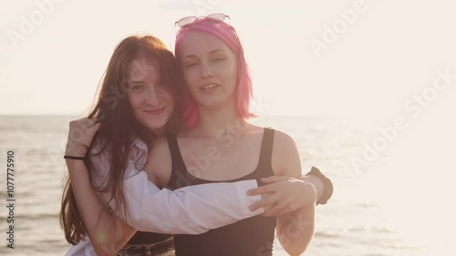 Summer vacation on beach. two Happy carefree women enjoy outdoor recreation and have fun by sea. portrait of friends on the background of the sea