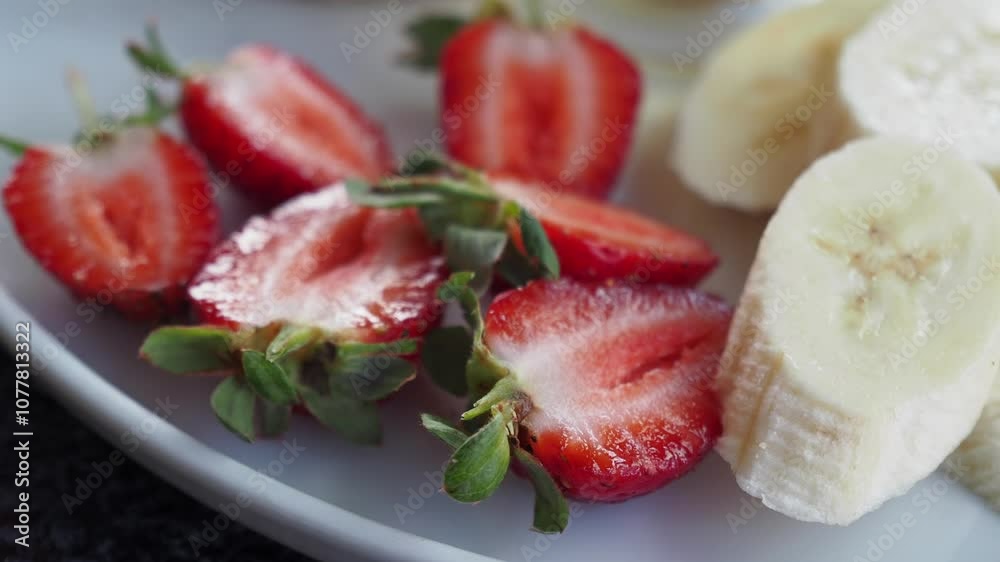 A Plate Beautifully Arranged with Freshly Sliced Bananas and Strawberries Awaiting You A Plate Beautifully Arranged with Freshly Sliced Bananas and Strawberries Awaiting You