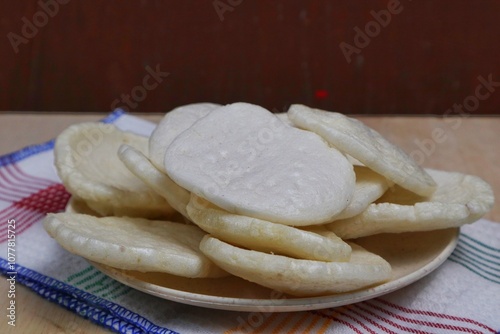 Fish crackers, Palembang crackers are a type of traditional Indonesian cracker originating from Palembang, Indonesia. Served on a wooden plate photo