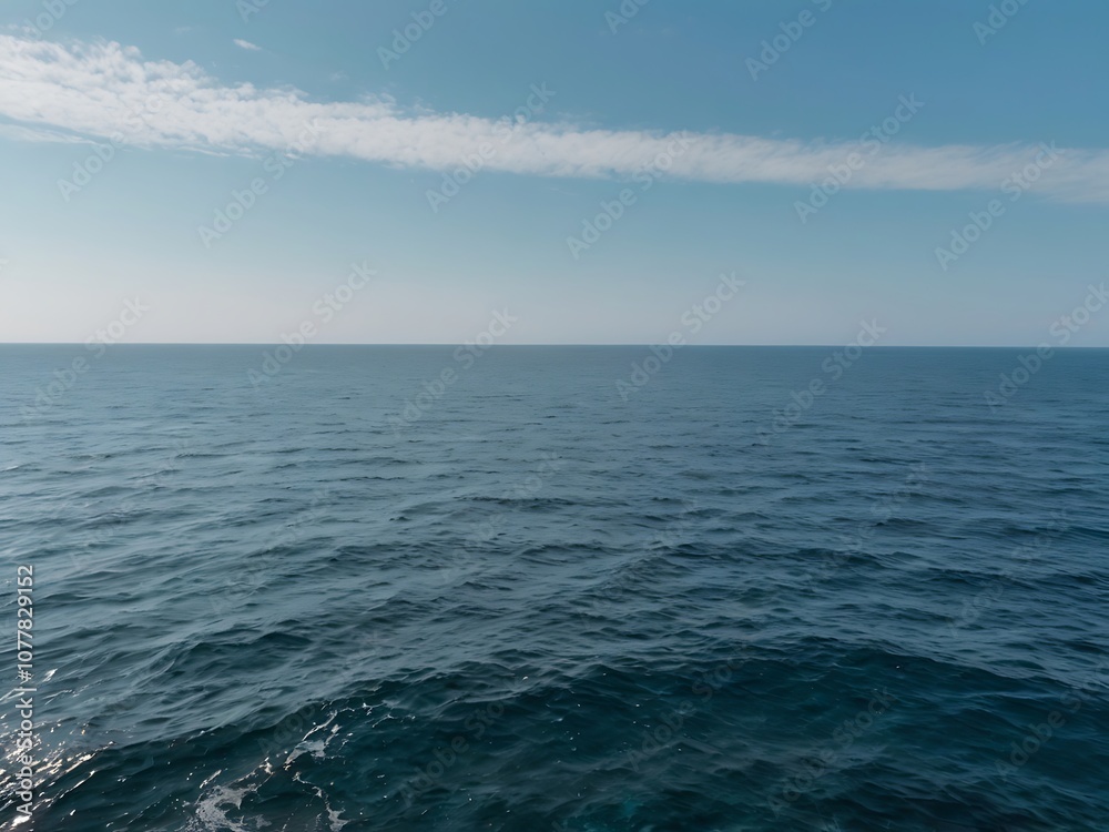 Blue Ocean Surface with White Clouds in the Sky Blue Ocean Surface with White Clouds in the Sky