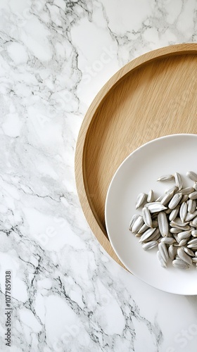 a close-up of a wooden tray filled with pumpkin seeds, nuts, walnuts, corn kernels, sunflower seeds, and cashews on a light-colored marble tabletop. This composition reflects themes of healthful livin photo