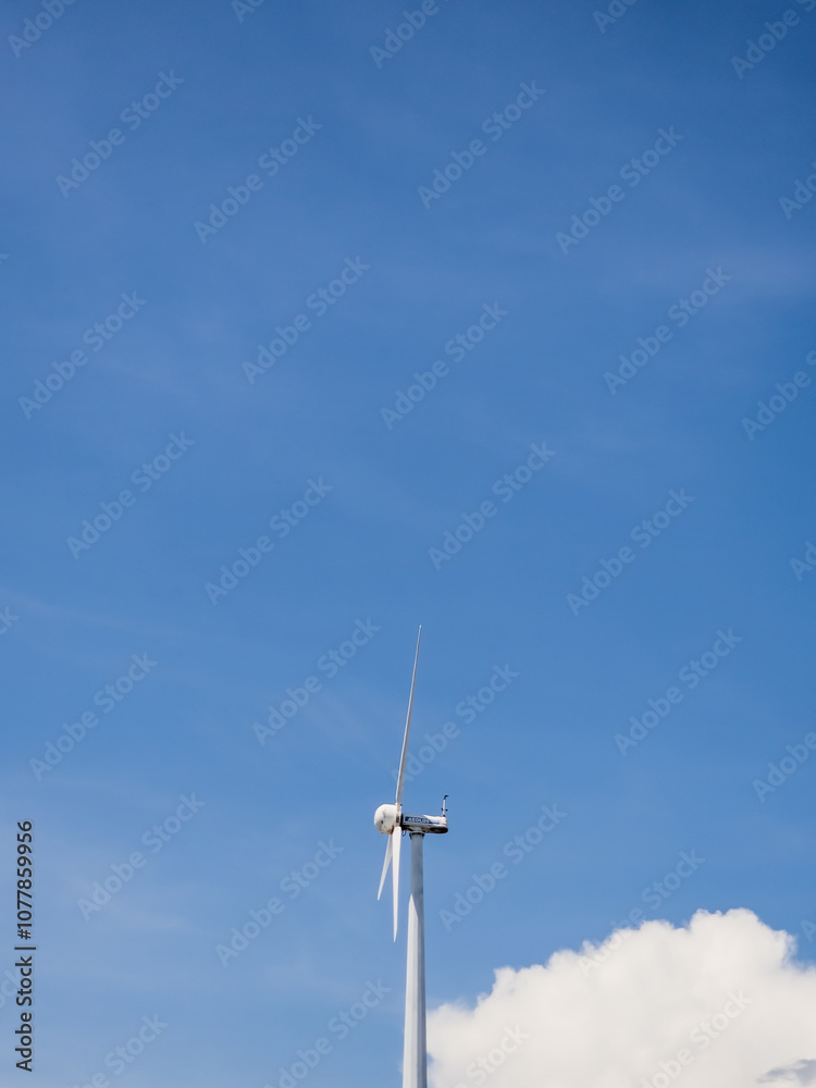 Close-up wind turbines or wind energy converter in sunny day with blue sky. Close-up wind turbines or wind energy converter in sunny day with blue sky.