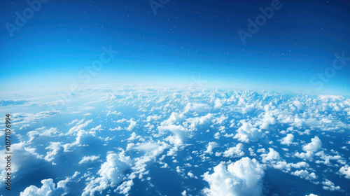 A panoramic sky view with rolling clouds across a deep blue backdrop, the horizon stretching into infinity