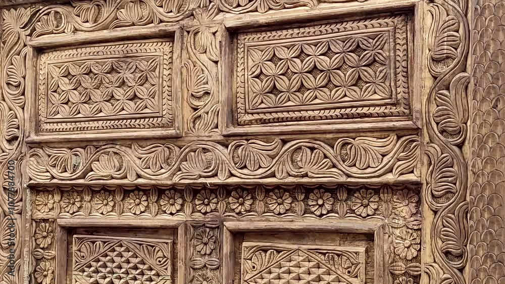 Detail of a carved ancient wooden door by craftsmen Detail of a carved ancient wooden door by craftsmen