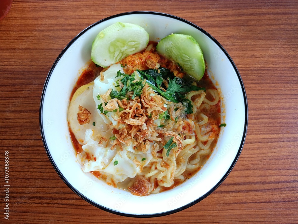 Fresh noodles with egg and vegetables served in a bowl.
