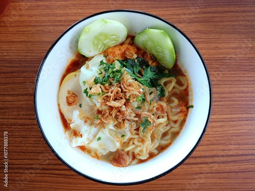 Fresh noodles with egg and vegetables served in a bowl.