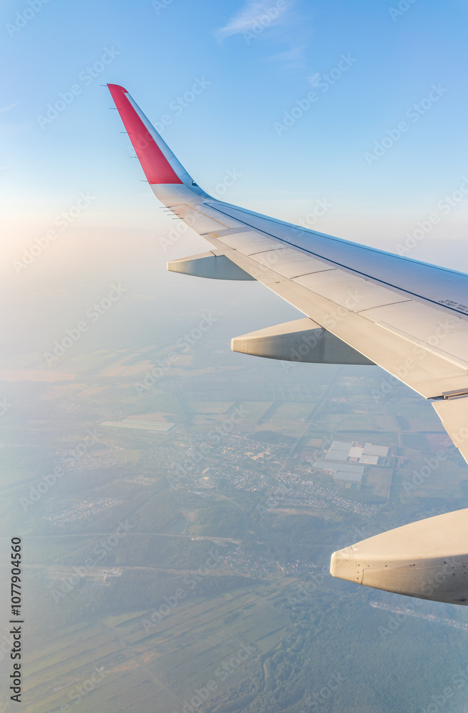 Obraz premium View from the airplane window at a beautiful cloudy sky and the airplane wing