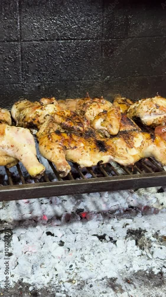 Cooking grilled chicken and chorizo Argentinean style. Vertical shot. Cooking grilled chicken and chorizo Argentinean style. Vertical shot.