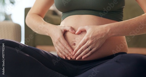 Woman, healing and heart hands with pregnancy on yoga in home with health, love and wellness. Mother, care and balance to relax for pregnant mama with abdomen, pilates and healthy body on floor