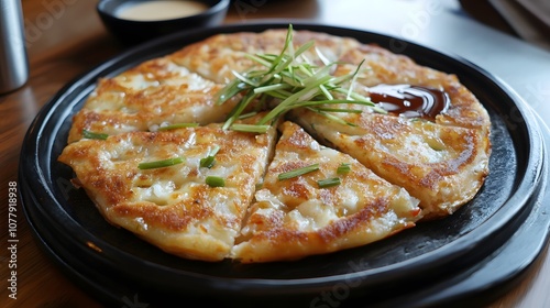 A serving of haemul pajeon, Korean seafood and green onion pancake, served with dipping sauce.


 photo