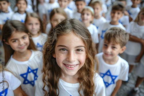 Wallpaper Mural A young girl with a big smile wearing a white shirt with a blue Star of David on it, surrounded by a crowd of children in similar shirts. Torontodigital.ca