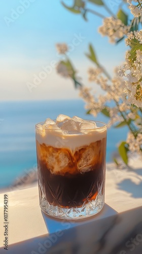 Sipping a frothy glass of Greek frapp coffee while taking in vibrant coastal scenery photo