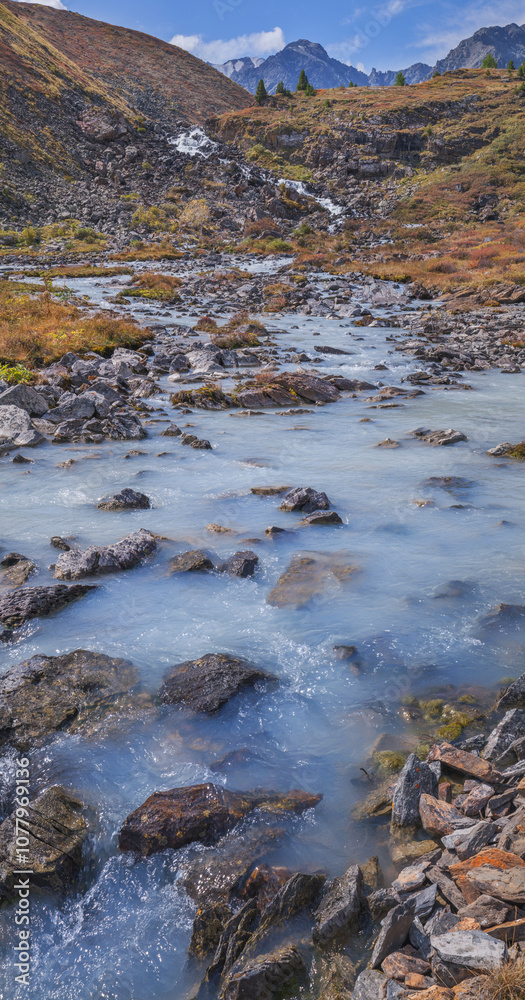Picturesque mountain stream, rough river, wild place, vertical photo Picturesque mountain stream, rough river, wild place, vertical photo