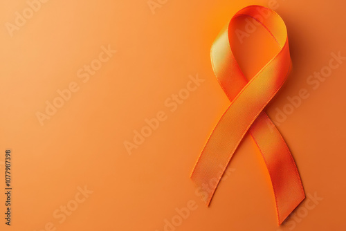 World Multiple Sclerosis Day. Horizontal banner. Copy space. Orange ribbon on a orange background for leukemia, kidney cancer, multiple sclerosis RSD awareness