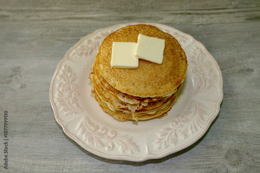 A delicious stack of pancakes with butter on top. hotcakes picture. A delicious stack of pancakes with butter on top. hotcakes picture.