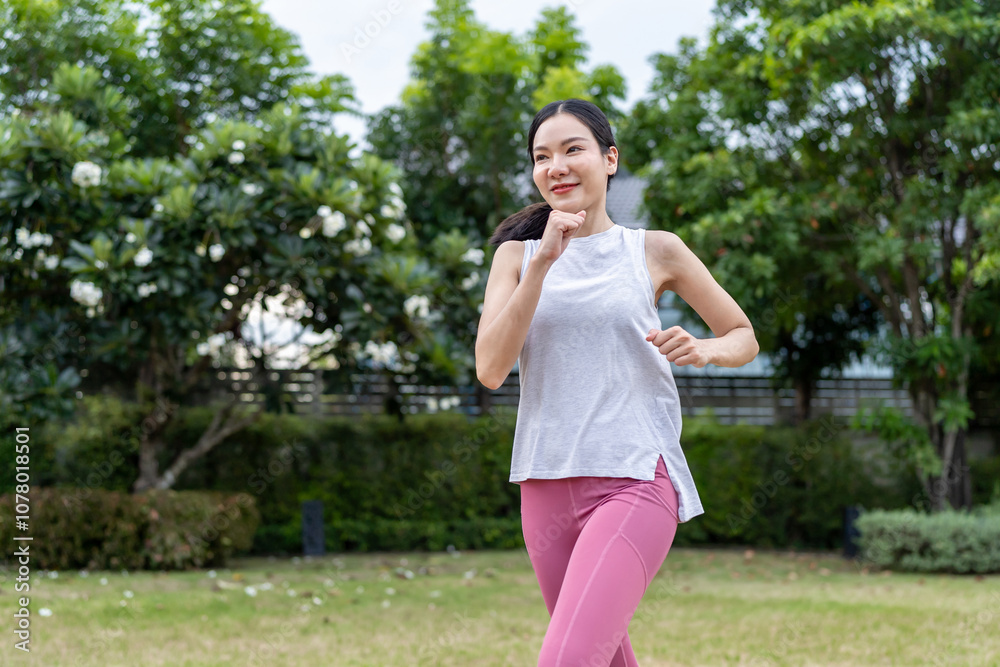 Asian beautiful sportswoman doing running exercise alone in the garden. Asian beautiful sportswoman doing running exercise alone in the garden.