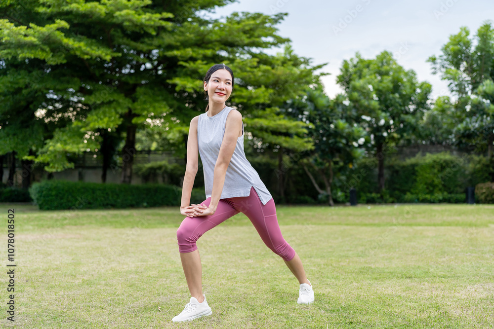 Asian woman stretching body before exercise in morning at public park. Asian woman stretching body before exercise in morning at public park.