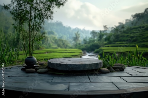 stone round podium stage with river stream and blurry green tea field in the background