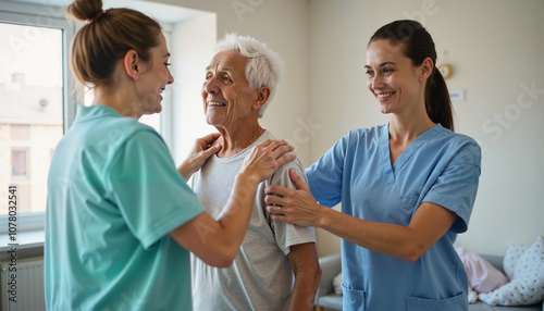Wallpaper Mural Compassionate caregivers interact joyfully with a senior man in a bright, welcoming room during a heartfelt moment Torontodigital.ca