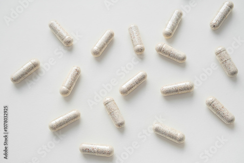Vitamin capsules, dietary supplement on light background. Supports for health concept.