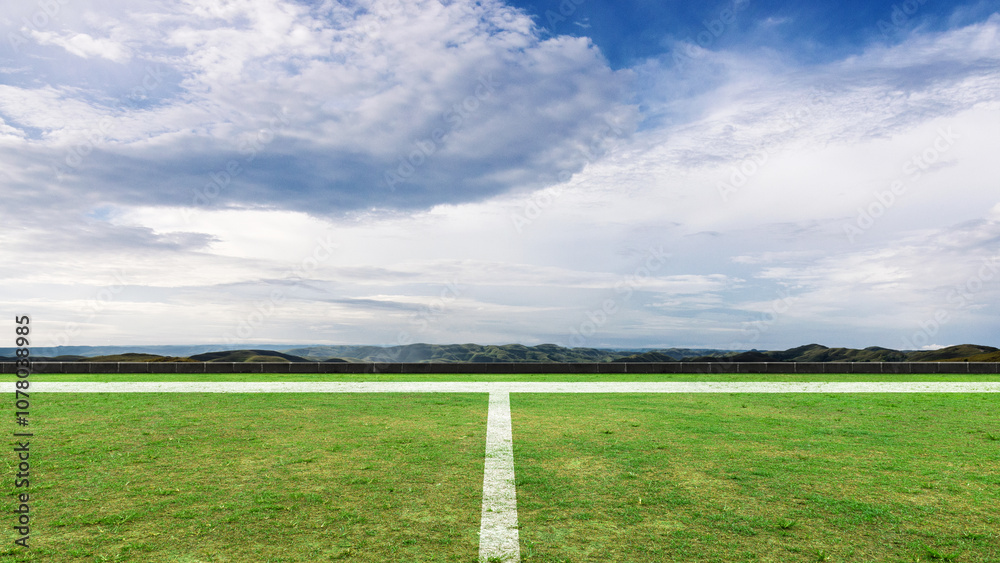 Empty football field with pitch line on green grass and blue sky. The field is ready for a game Empty football field with pitch line on green grass and blue sky. The field is ready for a game