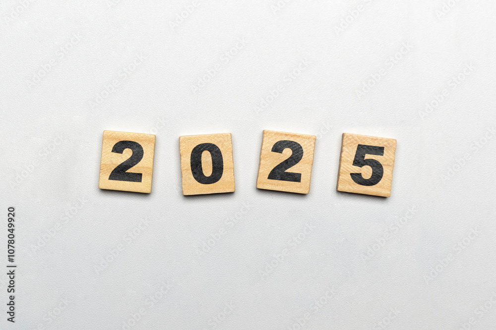 Obraz premium Wooden blocks with number 2025 on white background