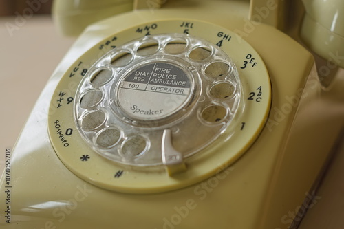 old rotary phone focusing on emergency number photo