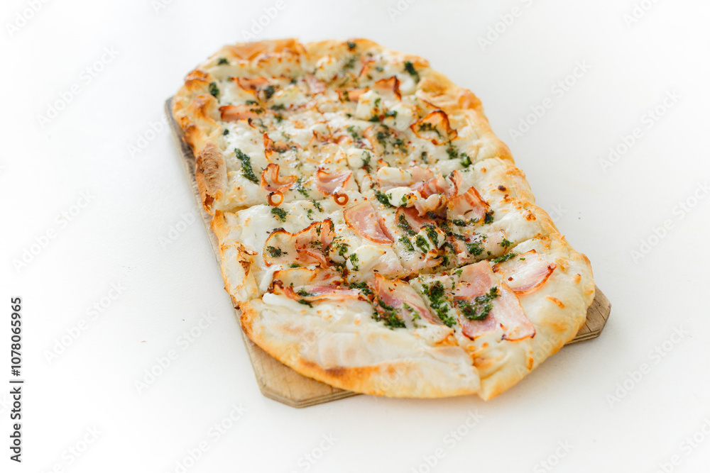 Pizza with bacon in Roman style served with fresh tomatoes on white table at cozy home Pizza with bacon in Roman style served with fresh tomatoes on white table at cozy home