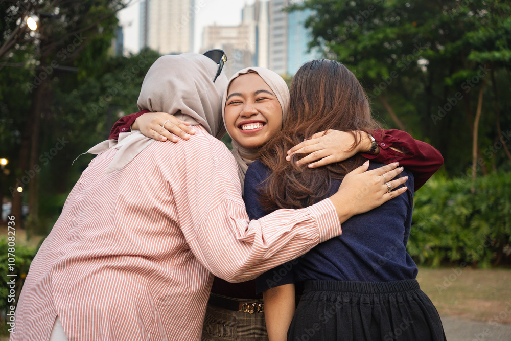 Fototapeta premium Three Indonesian happy best girl friends hugging each other with love in the city - Happiness and Friendship in Asia