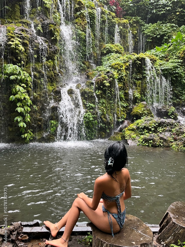 Fototapeta premium Young woman by the waterfall