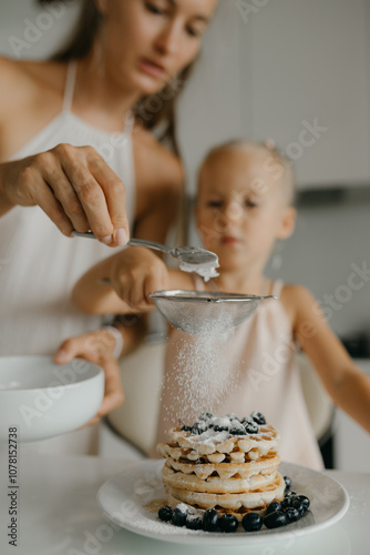 Mother and daughter preparing food in kitchen