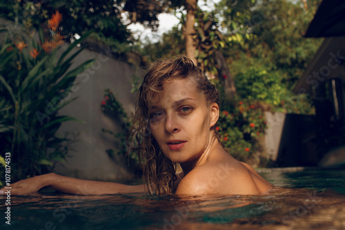 Happy woman swimming in pool on sunny day photo