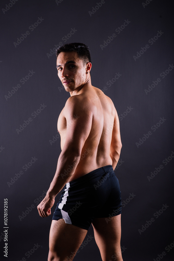 Fototapeta premium Muscular and torso of young man having abs, bicep and chest. Male hunk with athletic body.