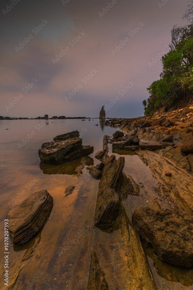 Coastal landscape at dusk with rocky shore. Coastal landscape at dusk with rocky shore.