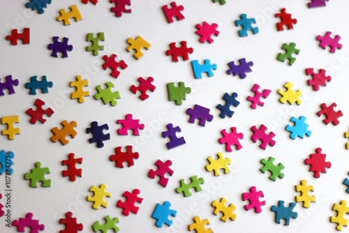 Colorful jigsaw puzzle pieces on white background. Selective focus.