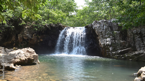 A hidden waterfall cascading into a serene pool, surrounded by lush forest and rocks, discovered by locals in a remote area  photo