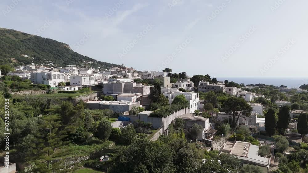 Aerial drone shot rising above Anacapri, unveiling the sea and mountains in the background on Capri Island Aerial drone shot rising above Anacapri, unveiling the sea and mountains in the background on Capri Island