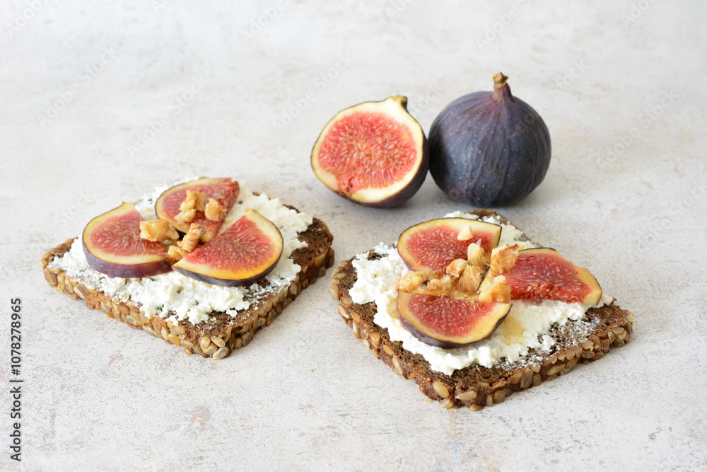 a square slice of wholegrain bread with figs and nuts on top a square slice of wholegrain bread with figs and nuts on top