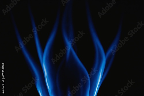 Abstract blue flame swirls against black background