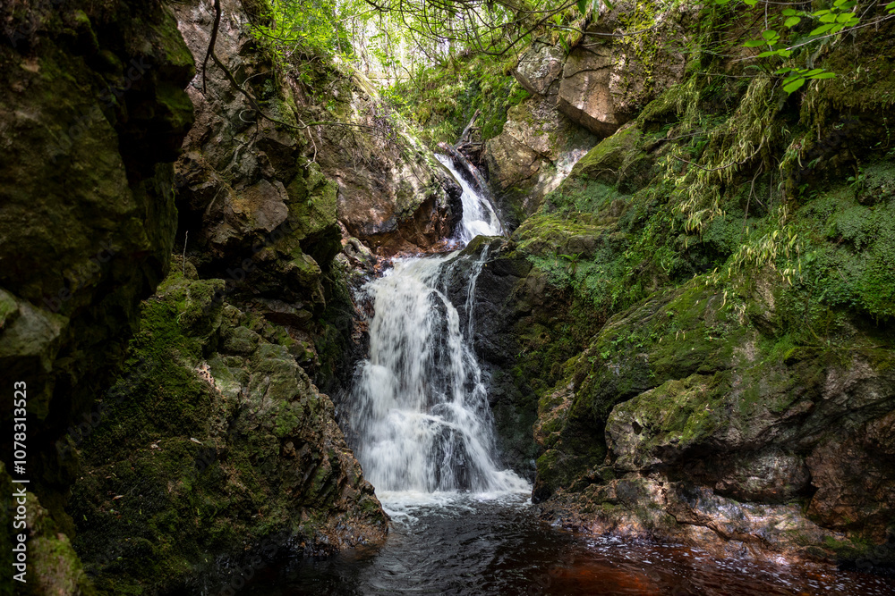 After a beautiful walk through the forest you will arrive at the Golspie burn waterfall, close to the town of Golspie, Scotland After a beautiful walk through the forest you will arrive at the Golspie burn waterfall, close to the town of Golspie, Scotland
