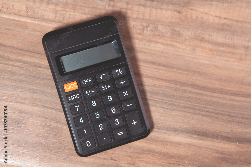 calculator on wooden background.business concept calculator on wooden background.business concept