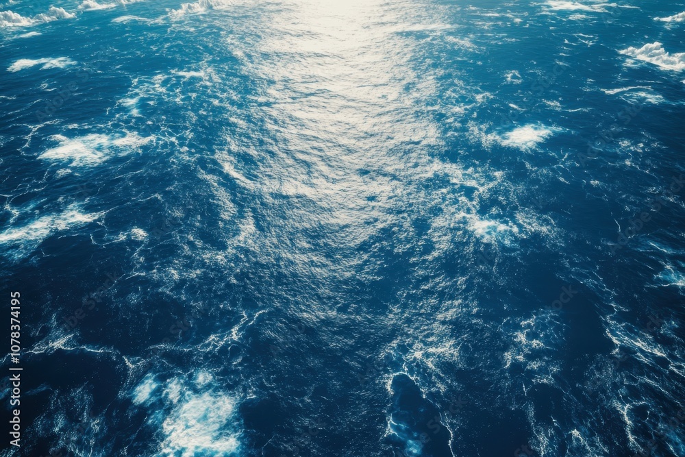 Fototapeta premium Captivating view of deep blue ocean waves under bright sunlight reflecting off the surface