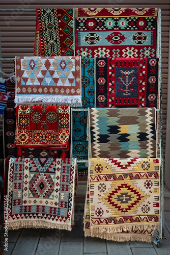 Colorful rugs selling in a street market in old town Vlore. Woven carpets with patterns and designs