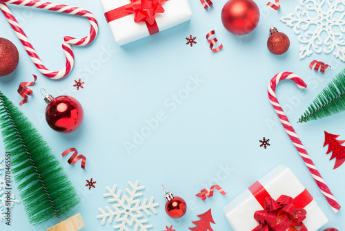 Christmas decor, gift boxes and confetti on color background, top view. Copy space for design