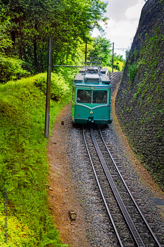 Fototapeta premium Electric railcar of the Drachenfels Railway (Drachenfelsbahn) on its way to the summit of the Drachenfels mountain, Königswinter, North Rhine-Westphalia, Germany