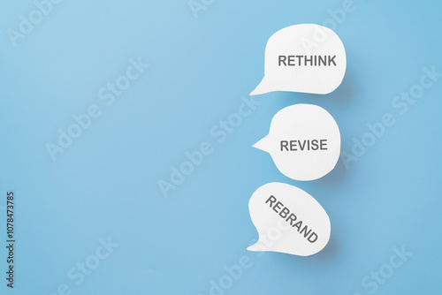 For business management branding concept of rethink revise and rebrand text on real paper cut speech bubble , copy space photo